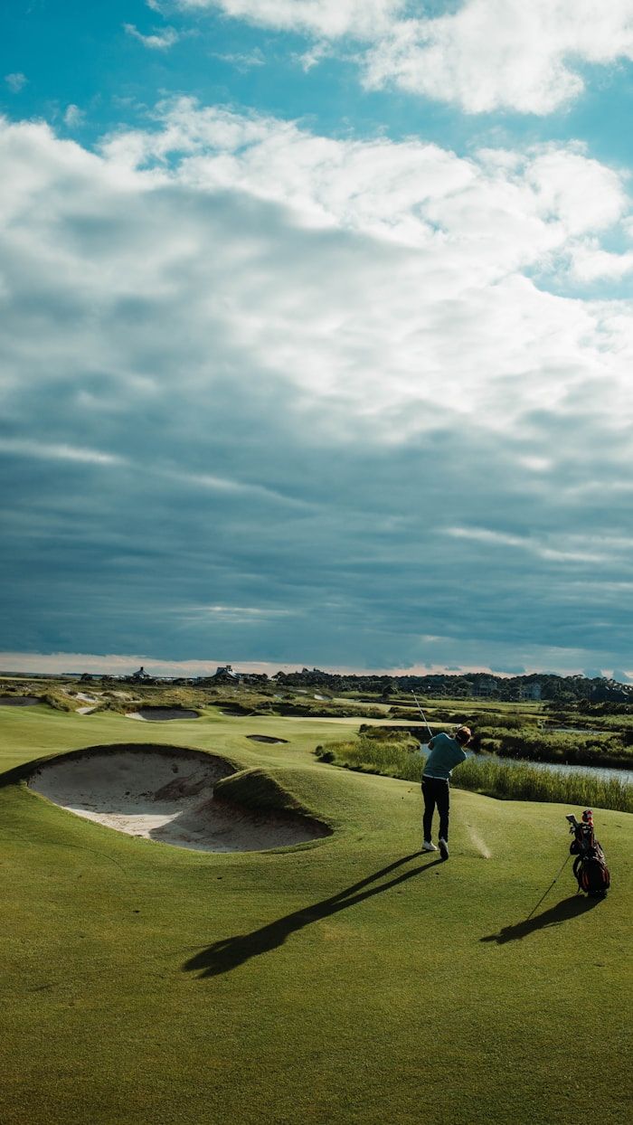 Golfer with bag on coastal course